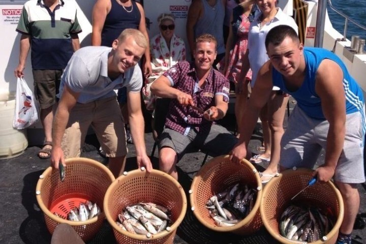 three men holding their fish