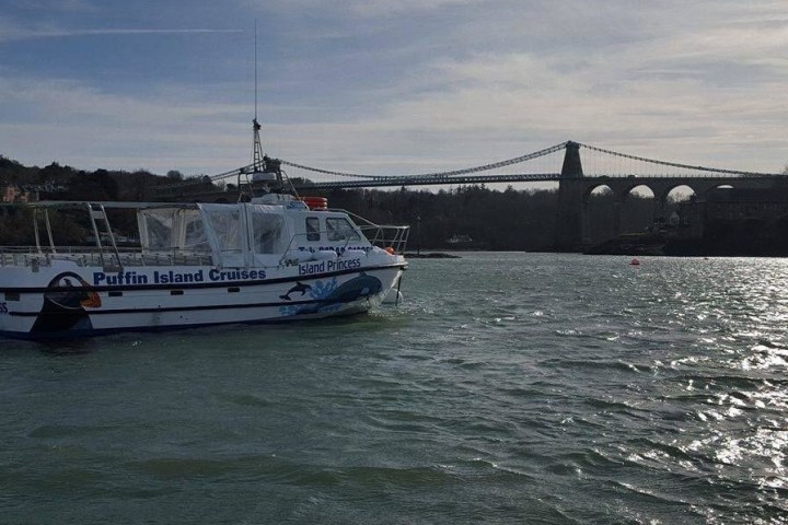 boat going under bridge
