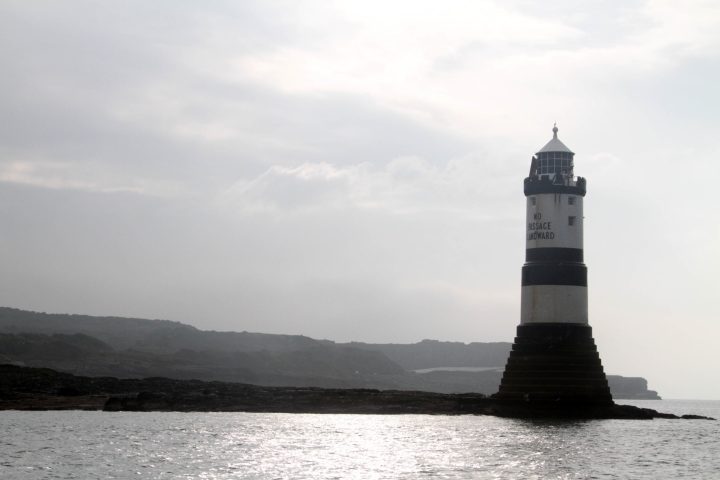 a large body of water with a mountain in the background